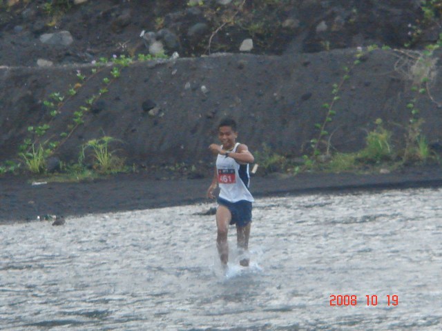Team Bald Runner Crossing the Yawa River First Among The Runners
