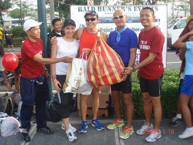 Jael & Cookie Wenceslao Turning-Over Bags Full of Running Shoes