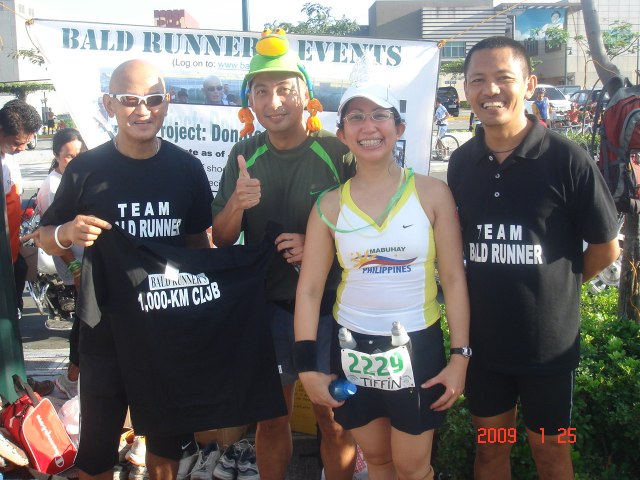 Mark Parco aka Mark's VO2 With Tiffin Receiving The Finisher's T-Shirt