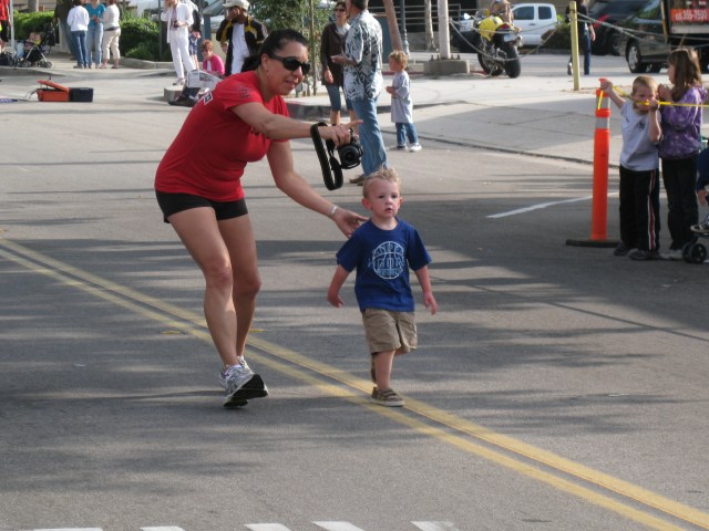 This Kid Kept On Going Back On the Road After Crossing The Tape At The Finish Line