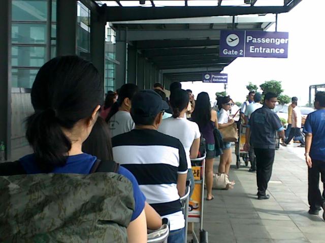Long Line of Passengers Before The Entrance of the terminal