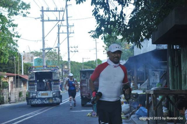 One Of The Last Runners After Gun Start (Using Two Hand-held Bottles)